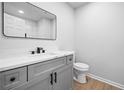 Bathroom featuring modern grey vanity, sleek black hardware and a well-lit mirror for optimal grooming at 3156 Ozmer Lndg, Decatur, GA 30034