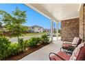 Inviting covered front porch with cozy seating, offering a serene view of the neighborhood street at 510 Cunninghame Ct, Peachtree City, GA 30269