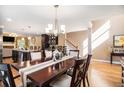 Stylish dining area featuring hardwood floors, a view of the kitchen, and elegant lighting fixtures at 1156 Magnolia Dr, Villa Rica, GA 30180