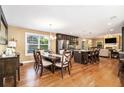 Bright, open dining area with hardwood floors, a view to the living room, and modern stainless steel appliances at 1156 Magnolia Dr, Villa Rica, GA 30180