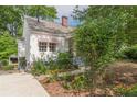 Charming exterior view of the house, featuring a well-maintained garden and quaint architectural details at 2669 Jefferson Terrace Ter, East Point, GA 30344