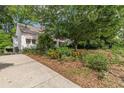 A charming home with a well-manicured front yard, showcasing a vibrant garden and a spacious driveway at 2669 Jefferson Terrace Ter, East Point, GA 30344