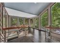 Bright hallway with large windows overlooking a green landscape and sleek metal railings for a modern touch at 4655 Latimer Ne Ct, Kennesaw, GA 30144