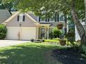 Inviting home with a well-kept lawn, stone bench, and lovely landscaping enhancing curb appeal at 10000 Barston Ct, Johns Creek, GA 30022