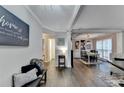 Open-concept living and dining area with hardwood floors and neutral decor at 10000 Barston Ct, Johns Creek, GA 30022