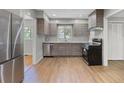 Modern kitchen featuring stainless steel appliances and gray wood-tone cabinets at 2215 Springdale Sw Rd, Atlanta, GA 30315
