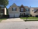 Charming two-story home with a well-manicured lawn and a two-car garage on a sunny day at 3692 Ramsey Cir, Atlanta, GA 30331
