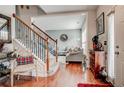 Inviting foyer showcasing hardwood floors, an elegant staircase with a wrought iron railing, and a glimpse into the living room at 3692 Ramsey Cir, Atlanta, GA 30331