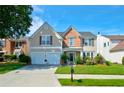 Charming two-story home featuring a well-manicured lawn, a two-car garage, and classic brick and siding accents at 3692 Ramsey Cir, Atlanta, GA 30331