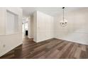 Bright dining room with modern chandelier and elegant wood floors at 420 Berckman Nw Dr, Lilburn, GA 30047