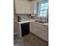 Efficient kitchen featuring sleek appliances, double sink, and a bright window at 929 Wexford Way, Auburn, GA 30011