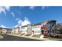 New townhome exteriors feature modern architecture and professional landscaping with a sidewalk in front of the property at 1598 Driggs Nw Dr # 163, Atlanta, GA 30318
