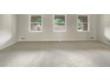 Spacious room with carpet and beautiful arched windows providing natural light and scenic views at 1710 Fontaine Dr, Jonesboro, GA 30236