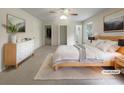 Comfortable main bedroom featuring a bed, white dresser, closet and a neutral color palette at 1710 Fontaine Dr, Jonesboro, GA 30236
