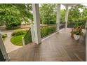 Relaxing covered front porch with herringbone-patterned floor provides a charming space to enjoy neighborhood views at 1764 Defoor Nw Ave, Atlanta, GA 30318