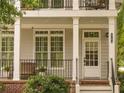 Inviting front porch features classic columns, a decorative railing, and a traditional white door with sidelights at 1764 Defoor Nw Ave, Atlanta, GA 30318