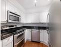 Kitchen with stainless steel appliances, white cabinetry, and granite countertop at 2870 Pharr Court South Nw # 1405, Atlanta, GA 30305