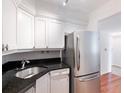 Kitchen with stainless steel appliances, white cabinetry, and granite countertop at 2870 Pharr Court South Nw # 1405, Atlanta, GA 30305