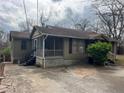 Side exterior view of home with screened porch and spacious driveway at 3143 Cedar St, Scottdale, GA 30079