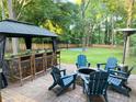 Outdoor entertaining space with a gazebo, fire pit, Adirondack chairs, and sport court at 550 Quillian Ave, Decatur, GA 30032