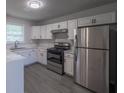 Modern kitchen with stainless steel appliances, white cabinets, and marble countertops at 5937 Yellowood Ct, Atlanta, GA 30349