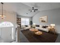 Cozy living room with lots of natural light, ceiling fan, neutral paint, and stylish decor at 5937 Yellowood Ct, Atlanta, GA 30349