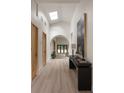 Bright hallway featuring high ceilings, skylight, light hardwood floors and an archway leading to living spaces at 1130 Mclinden Se Ave, Smyrna, GA 30080