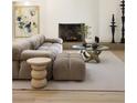 Bright living room featuring a tan sectional sofa, modern art, and a cozy fireplace at 1130 Mclinden Se Ave, Smyrna, GA 30080
