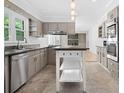 Bright kitchen featuring stainless appliances, ample cabinet space, and stone floors at 1425 Dalewood Ne Dr, Atlanta, GA 30329