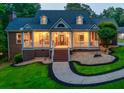 Beautiful two-story home featuring a manicured front yard, and a welcoming front porch with lighting at 2230 Ewing Chapel Rd, Dacula, GA 30019