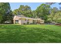 Traditional brick ranch-style home with large front yard and covered parking at 3301 Irish Ln, Decatur, GA 30032