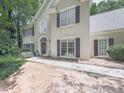 Charming home exterior featuring well-maintained landscaping, a red front door and neutral stucco at 4601 Ethel Springs Sw Trl, Mableton, GA 30126