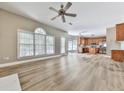 Open-concept living room with lots of windows, wood-look floors and a view to the kitchen at 4601 Ethel Springs Sw Trl, Mableton, GA 30126