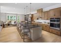 Modern kitchen featuring a large center island with bar stool seating, wood cabinets, and stainless steel appliances at 1492 Wicker Wood Se Pl # 24, Smyrna, GA 30080