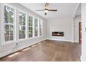 Bright living room featuring hardwood floors, large windows, and a sleek modern fireplace at 2411 Second Ave, Decatur, GA 30032
