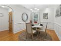 Bright dining room with hardwood floors, decorative mirror, chandelier, and modern furniture at 2825 Ellenwood Village Way, Ellenwood, GA 30294