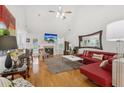Bright living room with fireplace, hardwood floors, modern furniture, and a vaulted ceiling at 2825 Ellenwood Village Way, Ellenwood, GA 30294