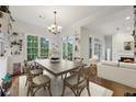 Sunlit dining room features large windows, hardwood floors, and modern light fixture at 3280 Stillhouse Se Ln # 212, Atlanta, GA 30339