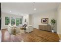 Bright living room features hardwood floors, fireplace, and large windows with a view at 3280 Stillhouse Se Ln # 212, Atlanta, GA 30339
