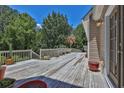 Long view of a wooden deck showing the planters and trees on a bright sunny day at 3909 Laurens Ln, Snellville, GA 30039