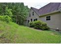 Home exterior with green lawn, mature trees, and neutral-toned siding at 3909 Laurens Ln, Snellville, GA 30039