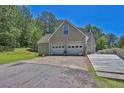 View of a two car garage with level driveway and a wheelchair access ramp at 3909 Laurens Ln, Snellville, GA 30039