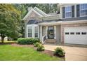 Front yard of a two-story home featuring well-maintained landscaping and an attached two-car garage at 4000 Mcpherson Drive, Acworth, GA 30101