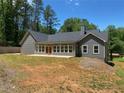 Exterior view of the back of the house, highlighting the large backyard and patio at 5950 Lynfield Dr, Atlanta, GA 30349
