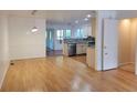 Open dining area with hardwood floors and a view into the kitchen with stainless steel appliances at 115 Davis Mill Ct, Lawrenceville, GA 30044