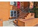Brick townhome close-up with staircase entry showing brick retaining wall and black iron handrails at 115 Davis Mill Ct, Lawrenceville, GA 30044