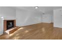 Living room with hardwood floors, freshly painted walls, and a brick fireplace at 115 Davis Mill Ct, Lawrenceville, GA 30044