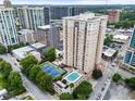 An aerial view showcasing the high-rise building, pool, tennis court, and surrounding neighborhood at 325 E Paces Ferry Ne Rd # 313, Atlanta, GA 30305