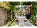 Outdoor dining area featuring a pergola draped in greenery, creating a charming atmosphere at 3734 Paige Ne Way # 10, Atlanta, GA 30319