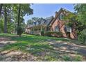 Beautiful brick home featuring a front porch and lush greenery at 3765 Cannonwolde Dr, Snellville, GA 30039